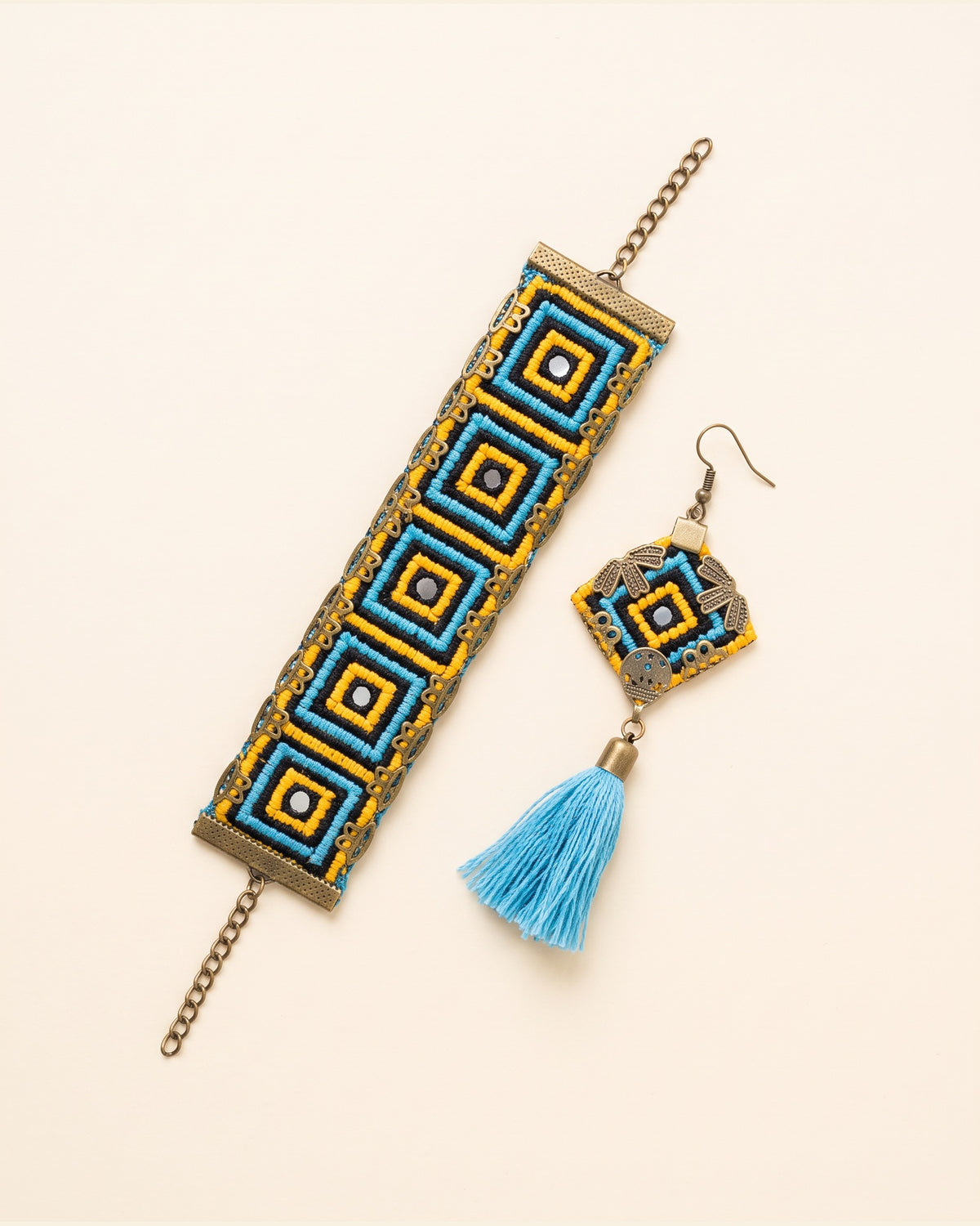 Handmade Balochi embroidered earrings and bracelet, yellow, blue — packshot
